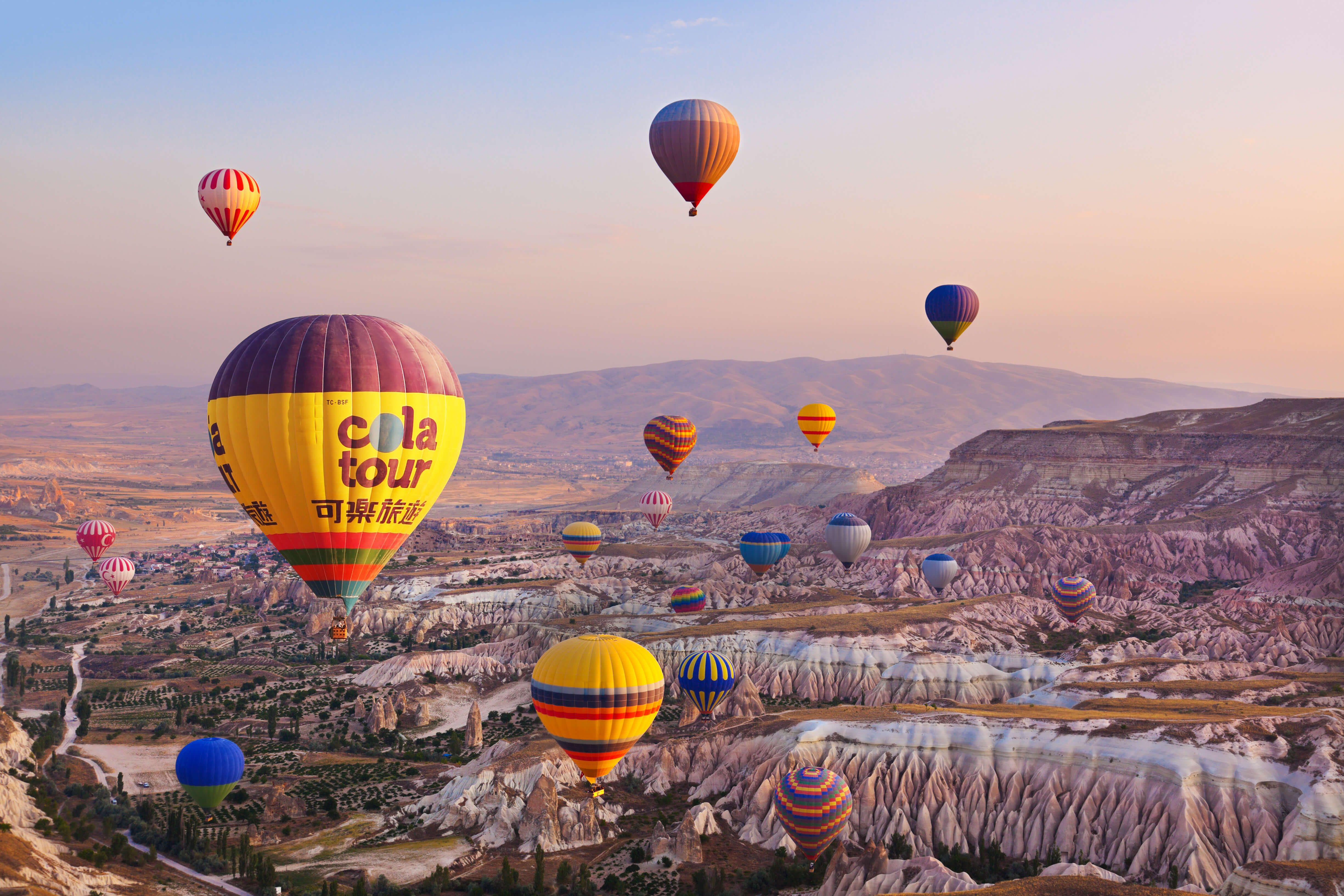 Hot air balloon flying over rock landscape at Cappadocia Turkey