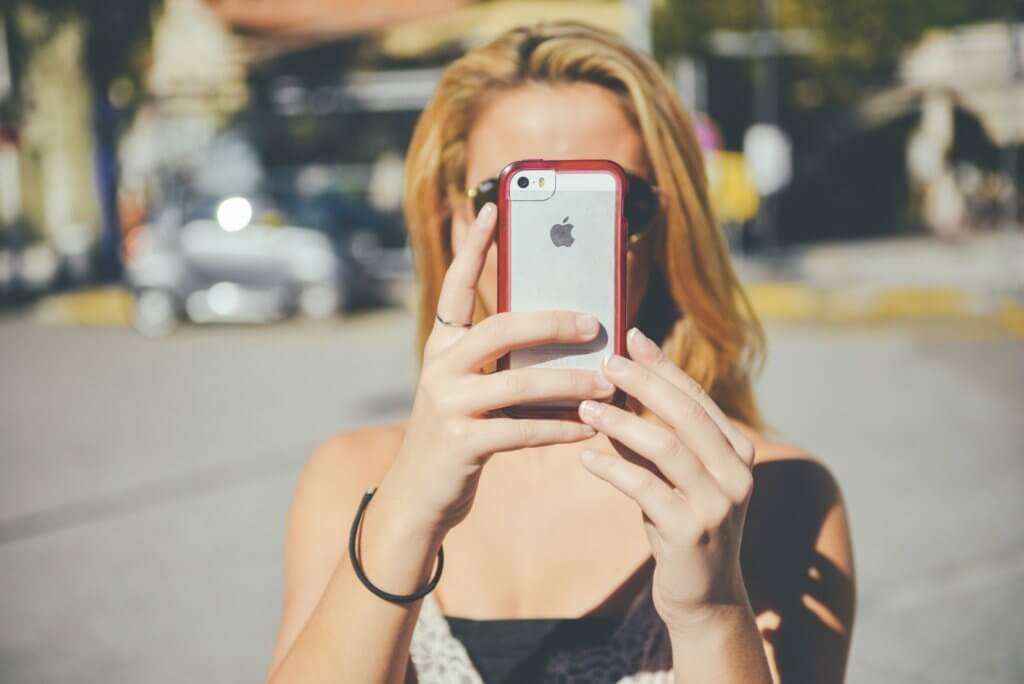 young-woman-photographing-self-on-sunny-day